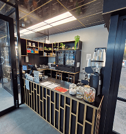 Davilia Location— Duncraig has Stylish café counter and modern black-and-gold interior design.