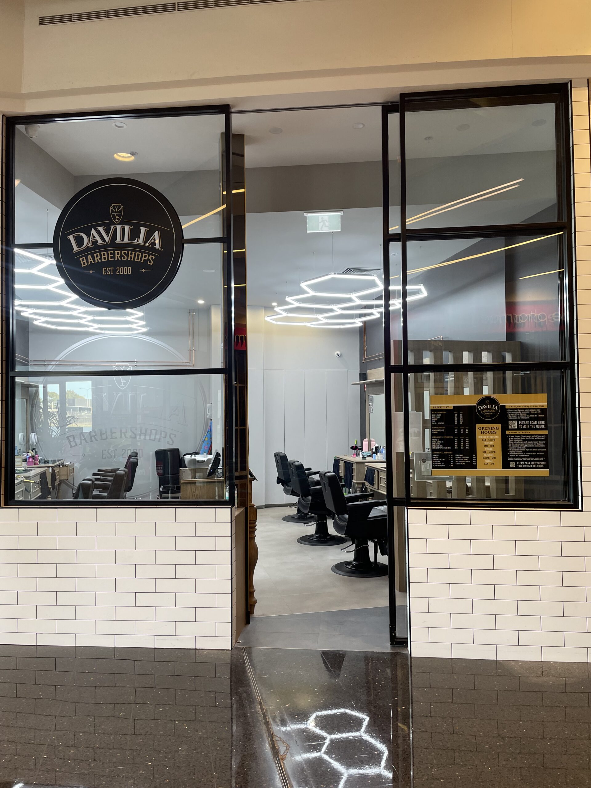 Barber cutting client's hair at Davilia Barbershop